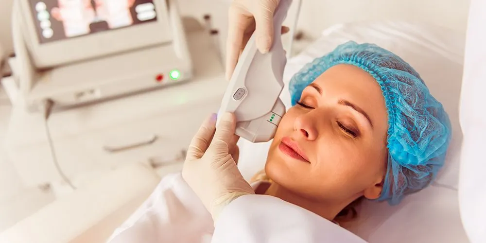 Professional aesthetic practitioner performing HIFU facial treatment